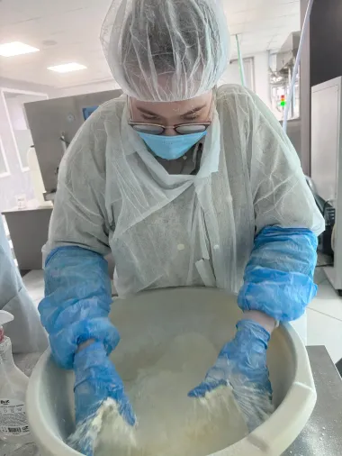 Technician in full protective equipment preparing a formulation